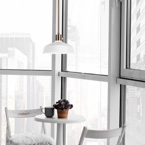 A white table and chair with a Canarm Bello pendant light above it.