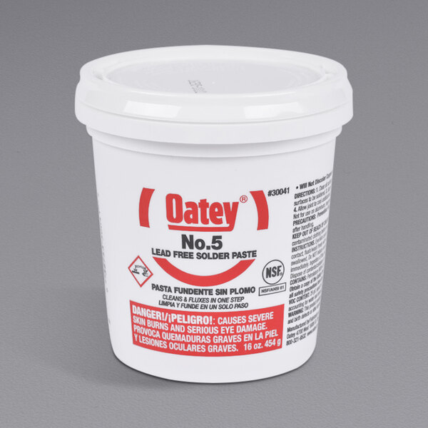 A white container of Oatey No. 5 soldering paste with a lid.