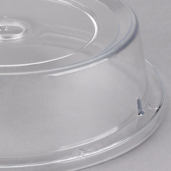 A clear plastic Cambro plate cover with a circular hole.