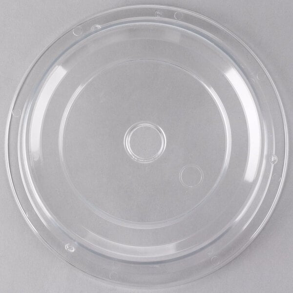 A clear plastic Cambro Camwear plate cover with a circular hole.