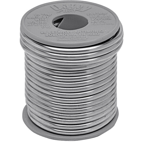 A close up of a spool of Oatey 95/5 plumbing wire solder with a hole in it.