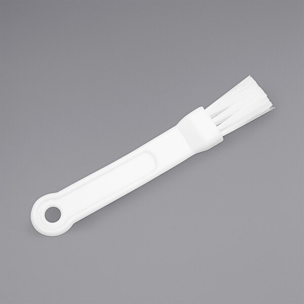 A white plastic ChocoVision baffle brush with a circle in the middle.