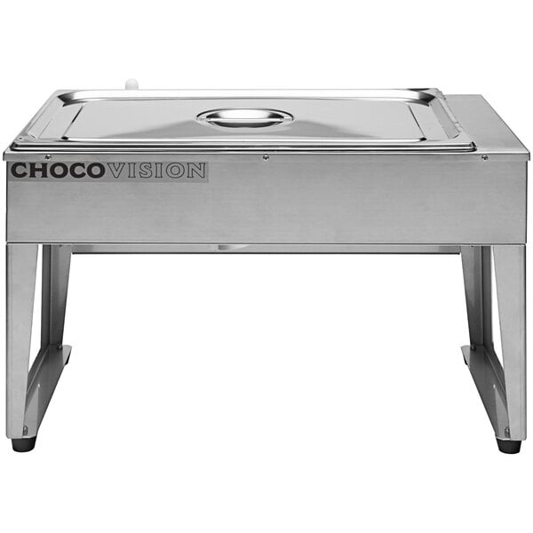 A ChocoVision chocolate drip feed melter on a rectangular metal tray with a round lid.