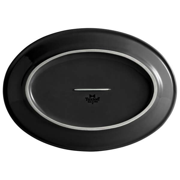 A black oval Tuxton China platter with a silver rim.