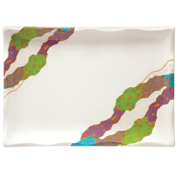A white rectangular melamine plate with wavy colorful edges.