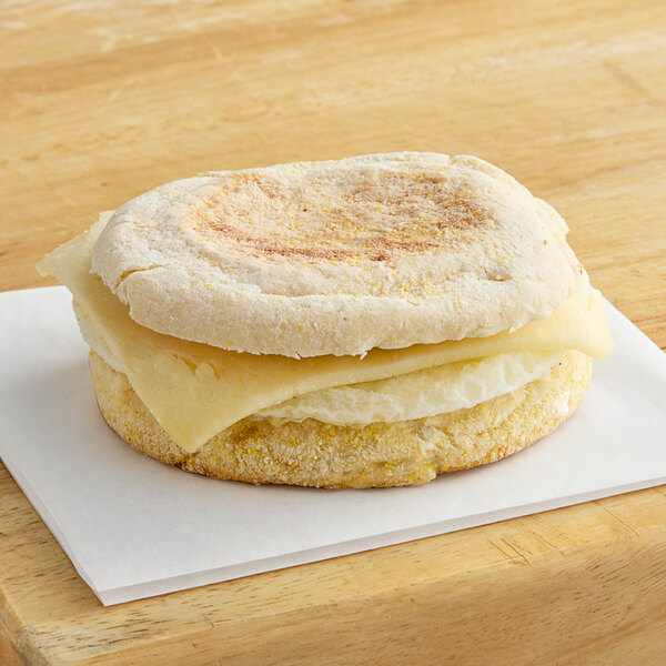 A Timber Ridge Farms breakfast sandwich with cheese on a toasted bun on a white napkin.
