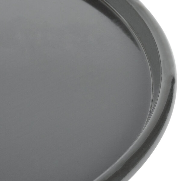 A close-up of a Chicago Metallic hard coat anodized aluminum pizza pan.