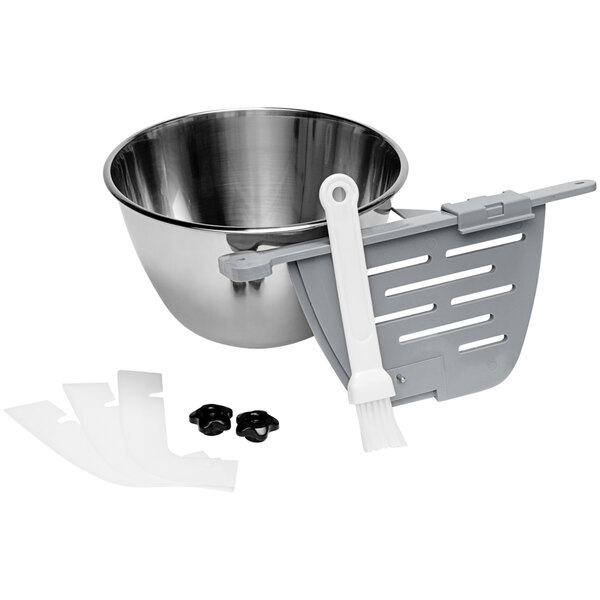 A metal bowl with a strainer and a brush.