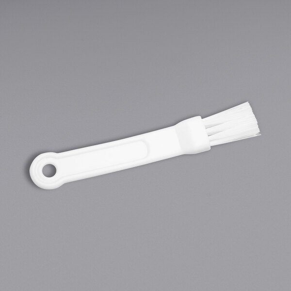 A white plastic ChocoVision Revolation 3Z baffle brush.