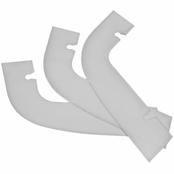 Three white plastic ChocoVision scrapers.
