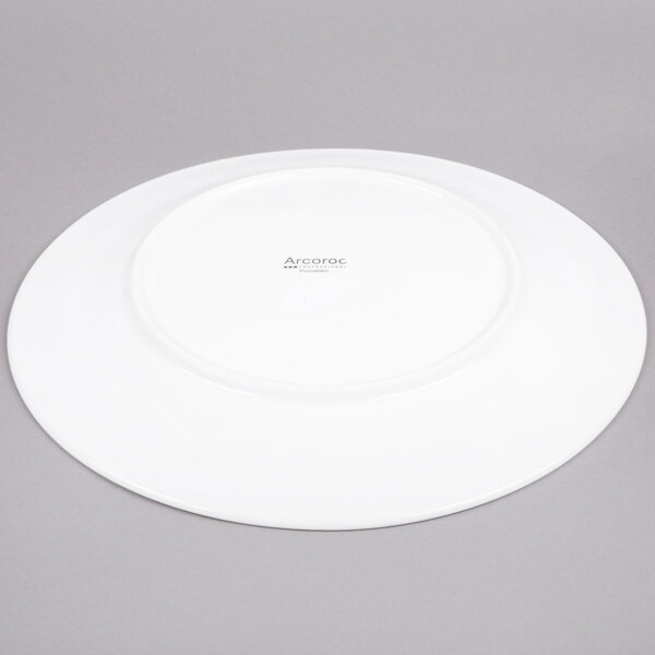 An Arcoroc white porcelain plate with a circular rim.
