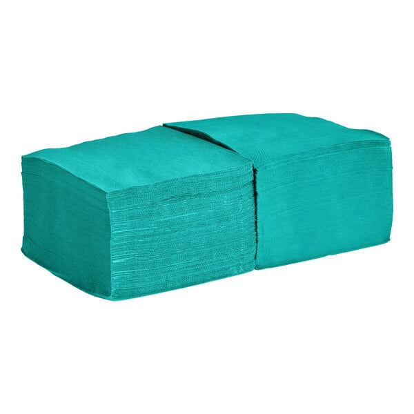 A stack of teal 2-ply beverage or cocktail napkins.
