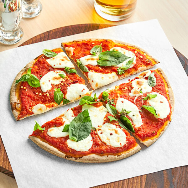 A Schar gluten-free pizza crust topped with cheese and basil leaves on a wooden tray.