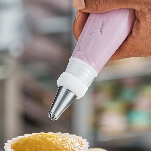 A standard plastic coupler attached to a piping bag for decorating baked goods.