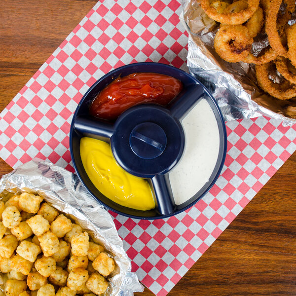 A blue plastic container with a blue lid holding a bowl of ketchup.