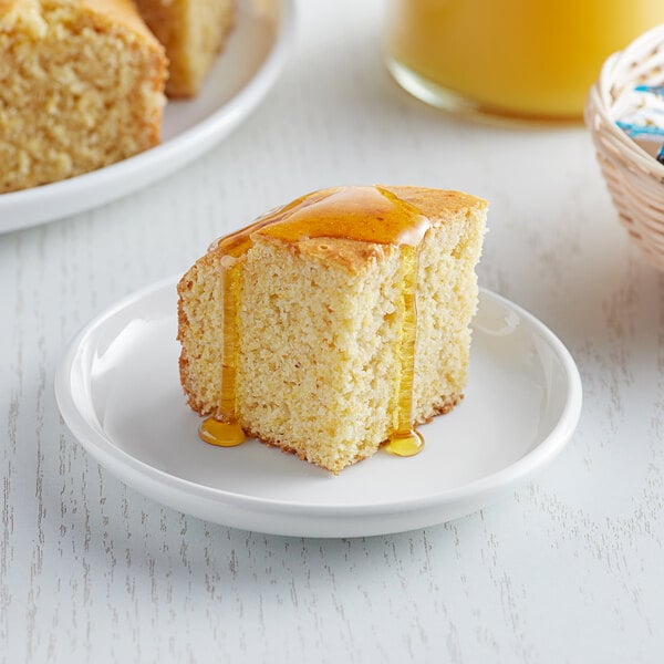 A piece of Krusteaz Professional honey cornbread on a plate.