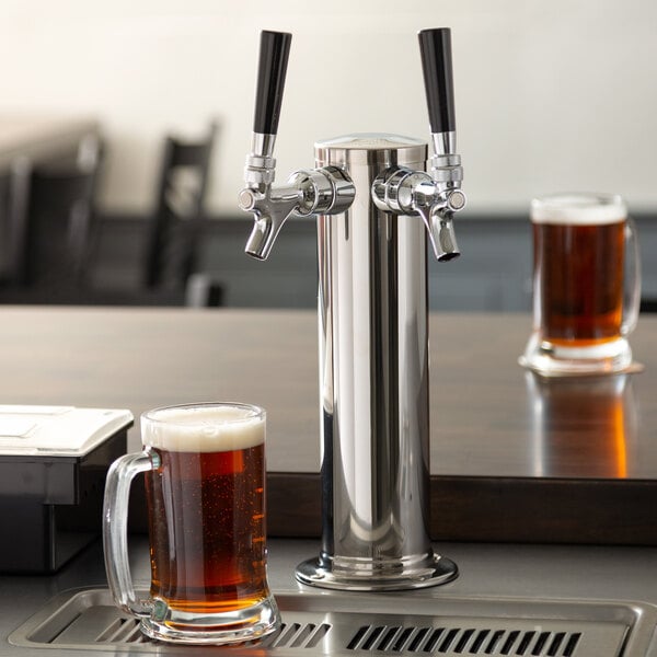A glass of beer next to an Assure 190DBLETOWER 2 tap tower.