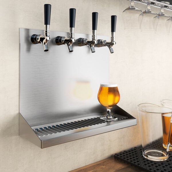 A Regency wall mounted beer drip tray with four beer glasses on it.