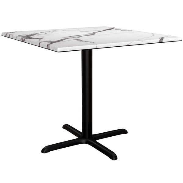 A white table with a black base.