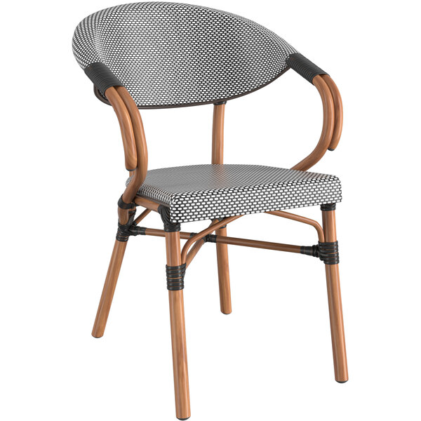 A black and white French bistro arm chair with wooden legs and a seat and backrest.