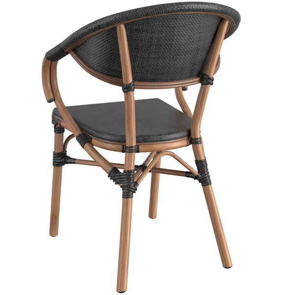 A black wicker arm chair with a wooden frame and black seat.