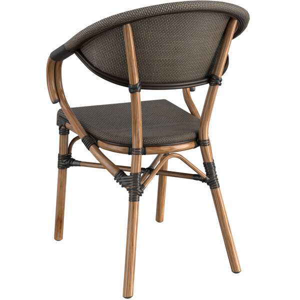 A Lancaster Table & Seating brown wooden arm chair with a black cushion on the seat and back.