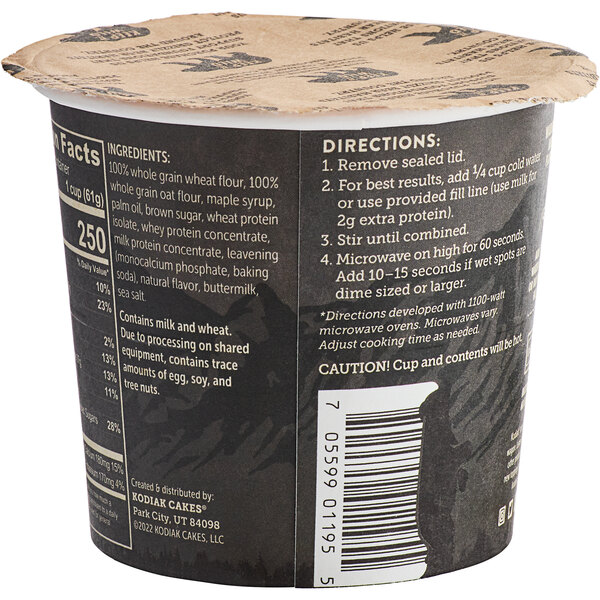 A black and white Kodiak Cakes container with text and a label on the side.