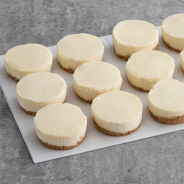 A tray of Tennessee Cheesecake Original Petite Cheesecakes on a white surface.