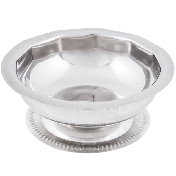 A silver paneled sherbet dish with a metal rim.