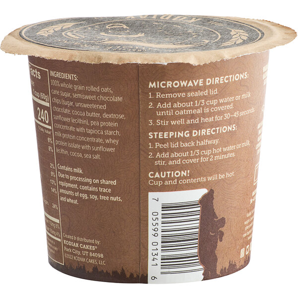 A brown and white Kodiak Cakes container with a label on a counter.