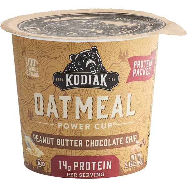 A Kodiak Cakes Peanut Butter Chocolate Chip Oatmeal power cup container on a table.