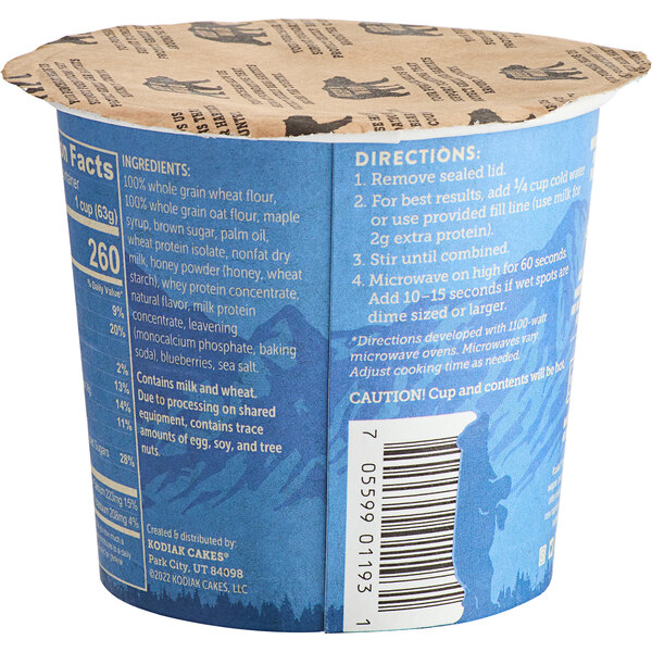 A blue and brown Kodiak Cakes Blueberry and Maple Flapjack Cup with a label.
