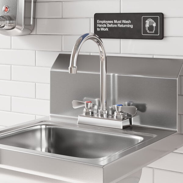 A stainless steel deck-mounted faucet with 4-inch centers and a 6-inch swivel gooseneck spout installed on a commercial sink.