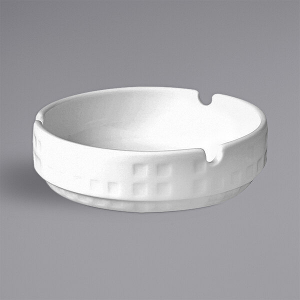 A white RAK Porcelain ashtray with an embossed white design.