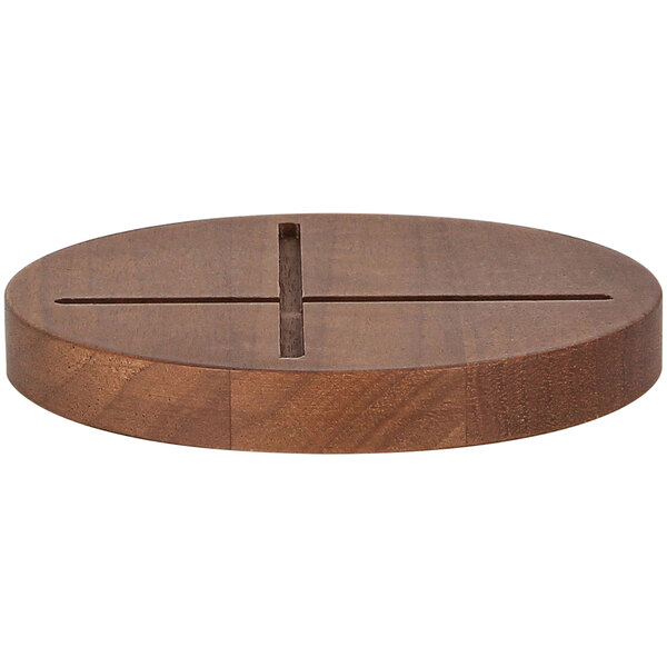 A RAK Porcelain wood round stand with a cross in the middle.