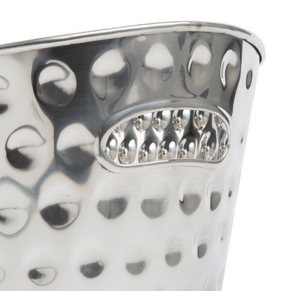 A close up of a silver Tablecraft Bali oval beverage tub with holes in it.