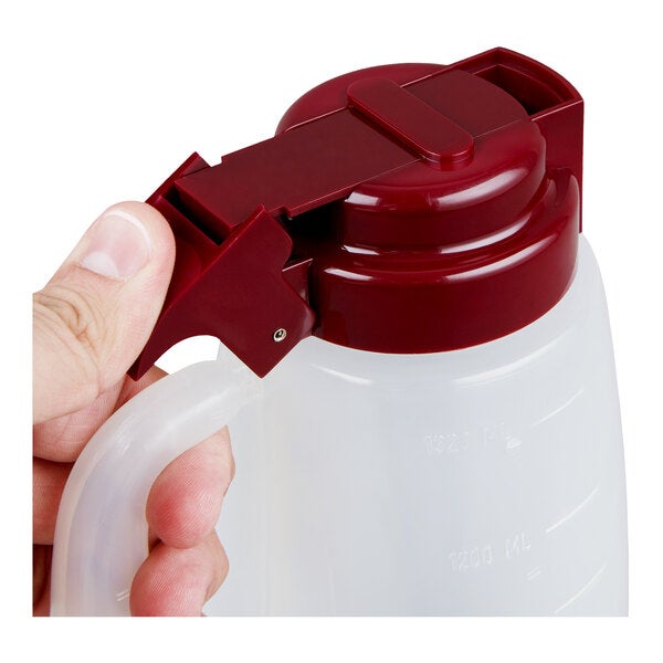 A plastic dispenser jar with a maroon flip-top lid and handle.