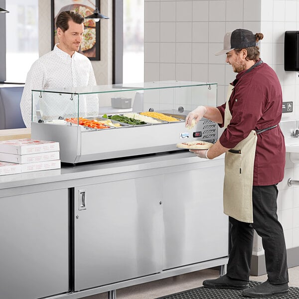 An Avantco countertop refrigerator with food on display.