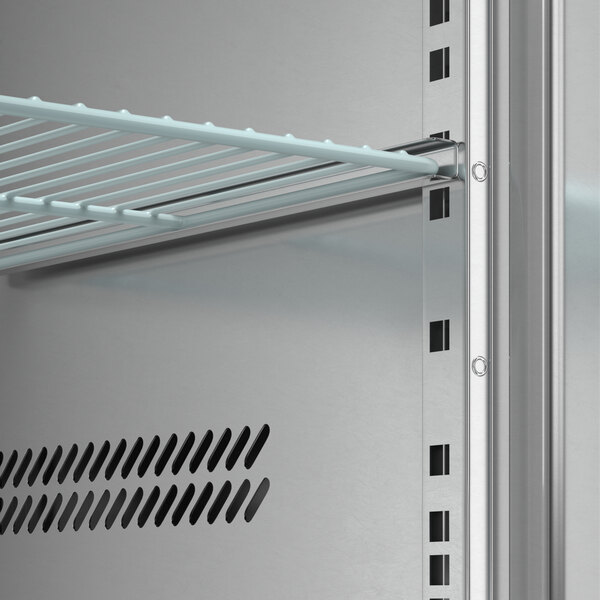 An Avantco 3 door pizza prep table with a metal shelf and shelf rack.