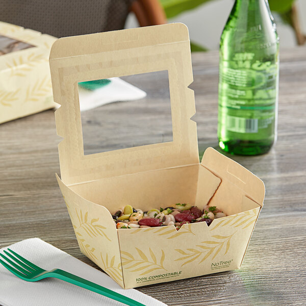 A World Centric eco-friendly to-go container with food inside and a PLA window.