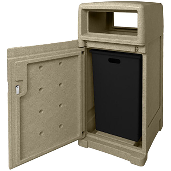 A Busch Systems sandstone plastic trash can with a black lid and door open.