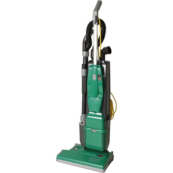 A close-up of a Bissell Commercial green dual motor upright vacuum cleaner with yellow nozzles.