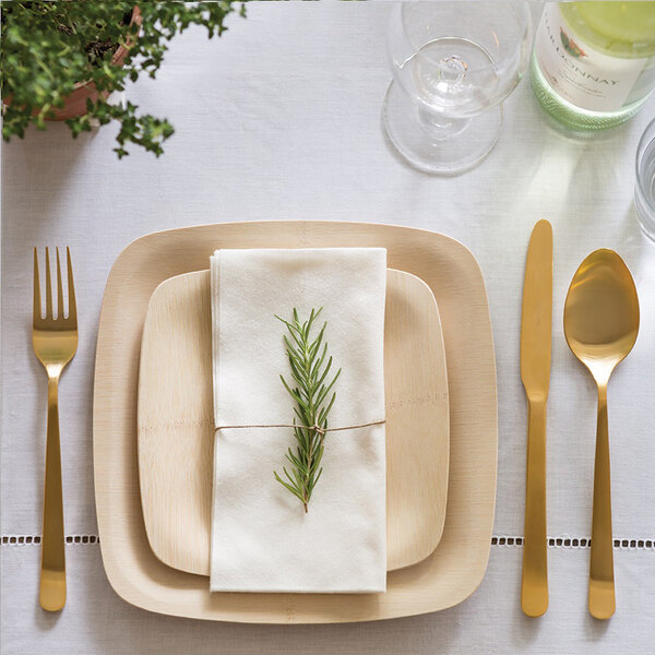A Bambu square bamboo plate with a rosemary plant on a table