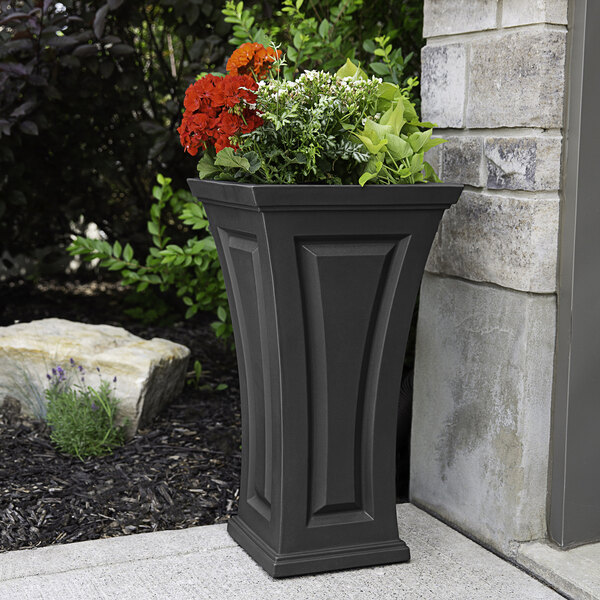 A graphite gray rectangular planter with flowers in it.
