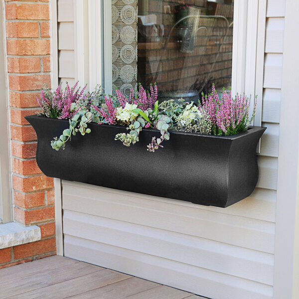 A black Mayne Valencia window box with purple flowers.