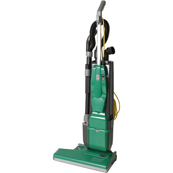A close-up of a Bissell Commercial green and black upright vacuum cleaner with nozzles on the back.