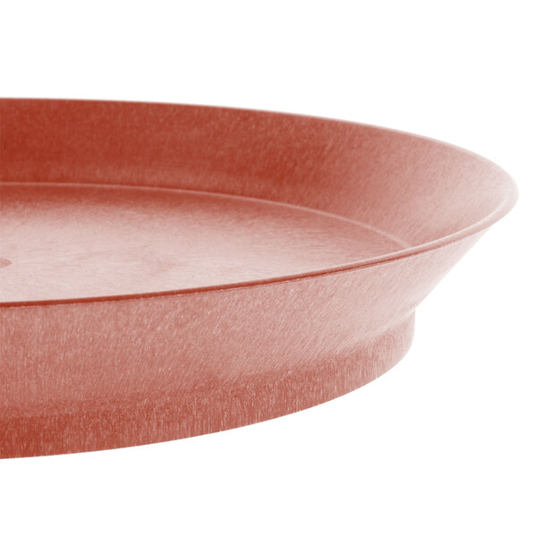 A close-up of a red round HS Inc. polypropylene deli server on a table.