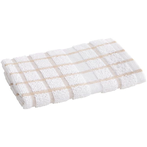 A white dish cloth with a tan windowpane checkered pattern.