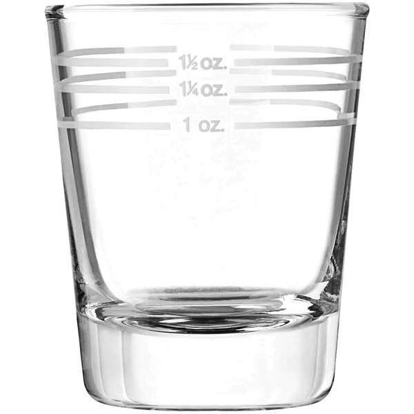 A clear Libbey shot glass with white measurement lines.