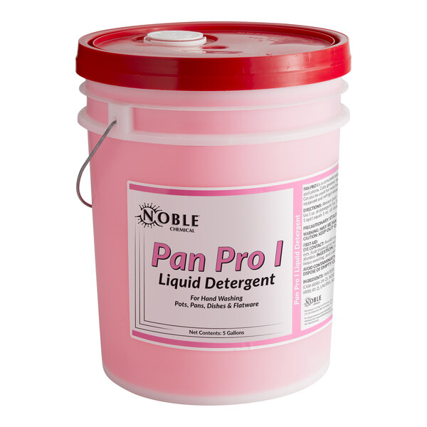 A pink bucket of Noble Chemical Pan Pro liquid detergent with a red lid on a counter in a professional kitchen.